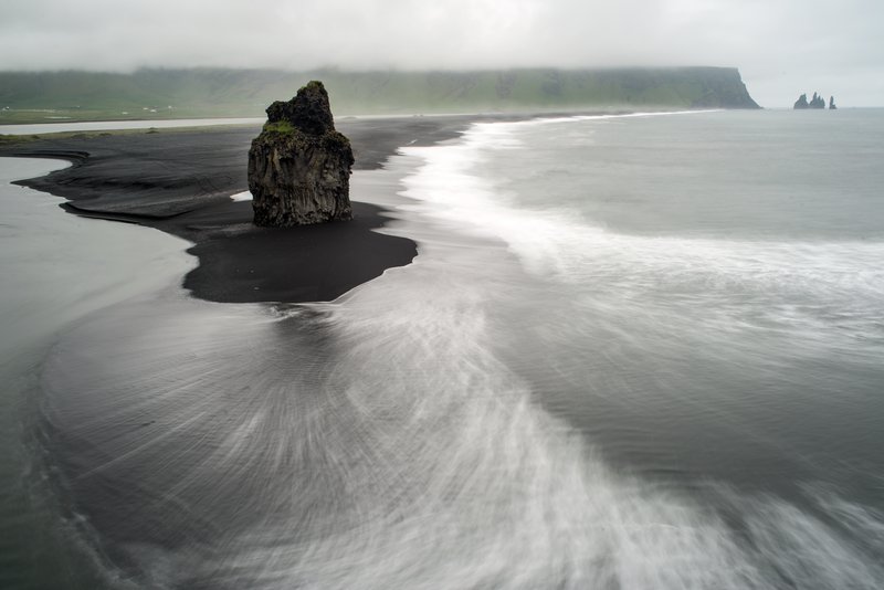 At the western end of Reynisfjara you can spot Háadrangur, a striking solitary rock pillar rising from the black sand. Photo: Haukur Snorrason