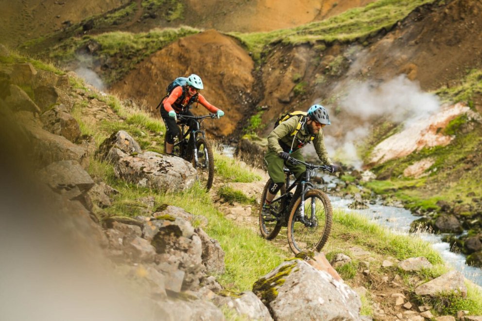 Mountain bikers riding through steaming geothermal valleys in South Iceland. Photo Credit: Icebike A&hellip;