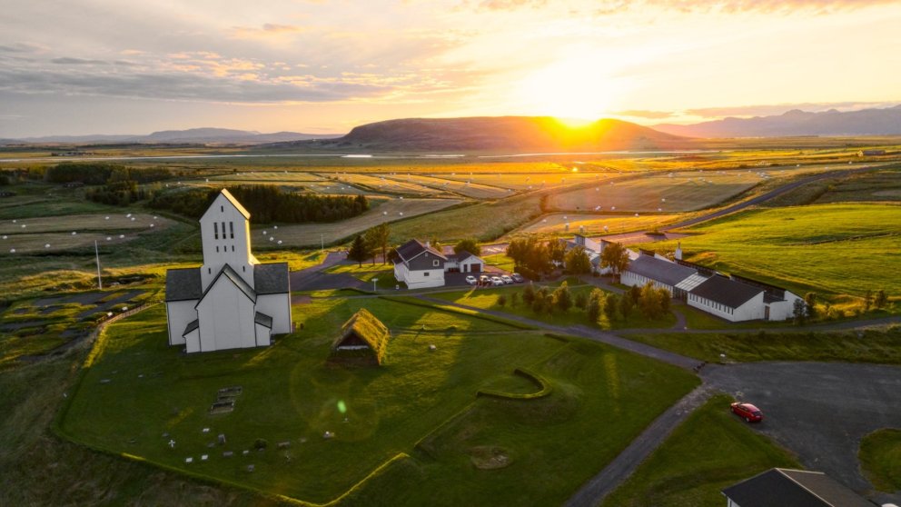 Skálholt with the Icelandic flag at sunset