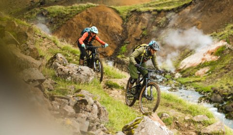 Mountain bikers riding through steaming geothermal valleys in South Iceland. Photo Credit: Icebike A&hellip;